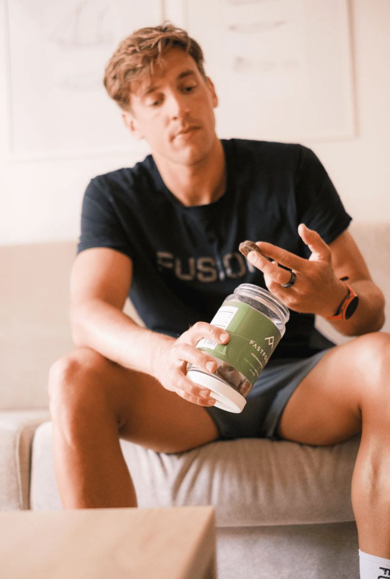 Jesper Svensson, triathlete, eating a FastFood energy gummy